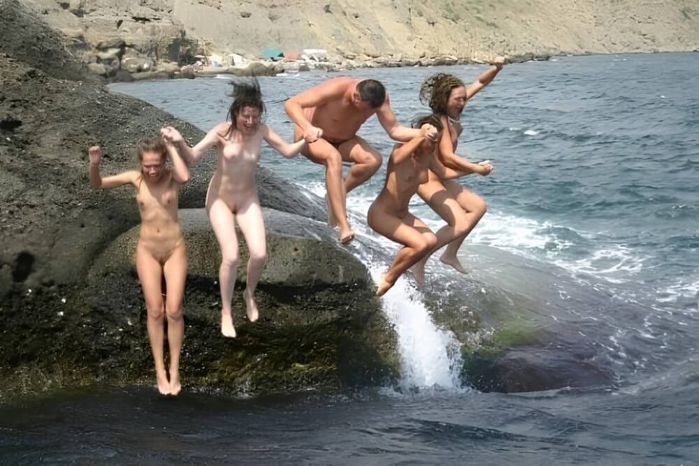 Mens and girls nudists on a beach - Naturism is based on love for oneself and nature