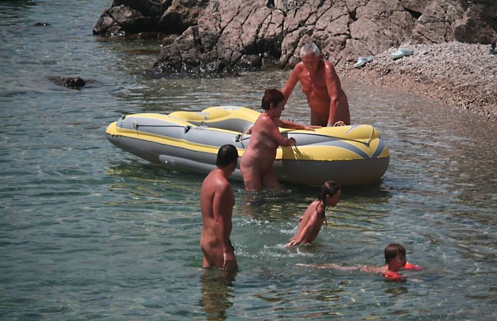 Lone Nudist in Yellow Boat photos - Naturism and respect for nature