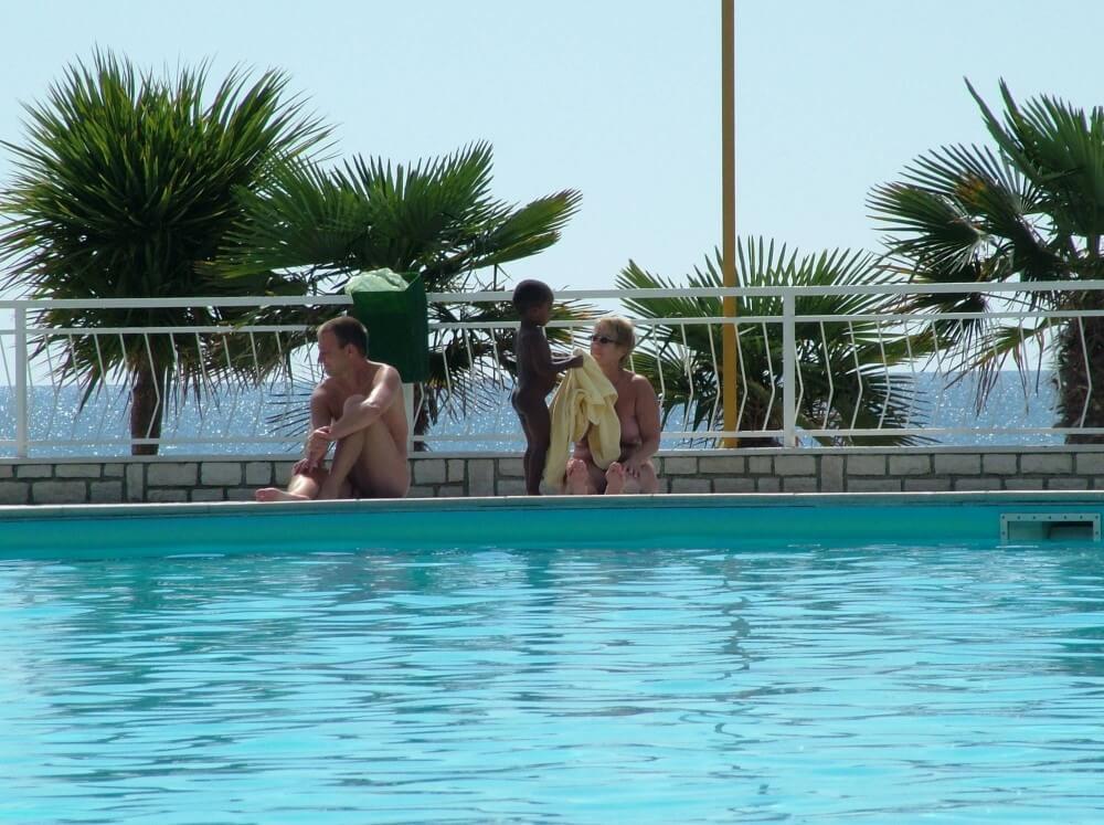 Photo of naturists in an outdoor pool - It strives for inner balance—not being afraid to be naked among those like you